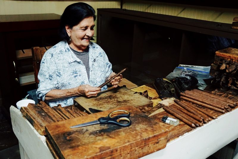 Founder Daniela Rodriguez rolling the final wrapper on a cigar at Rodriguez Cigar Factory in Key West