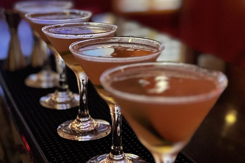 A row of Hemingway Papa Doble daiquiris lined up along the bar at The Saint Hotel in Key West