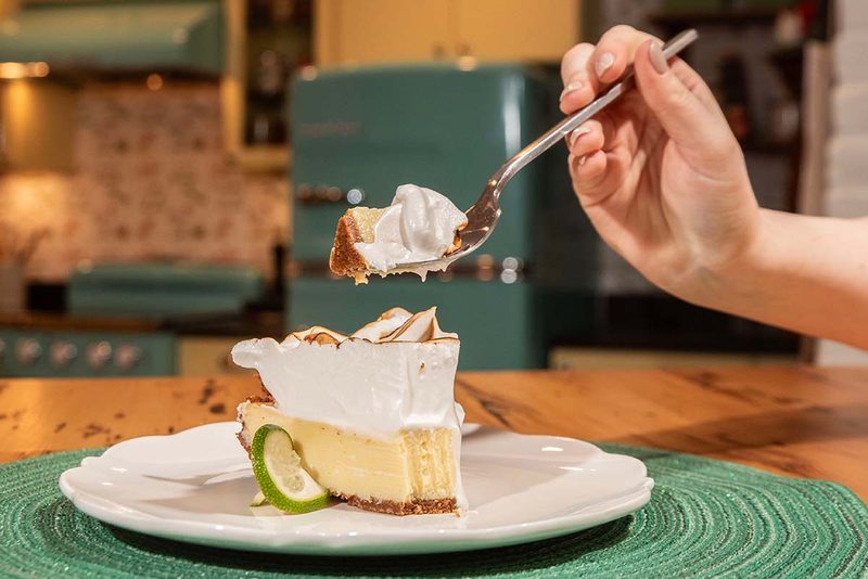 Forkful lifted from a slice of meringue-topped Key lime pie in the retro kitchen at the Key West Cooking School
