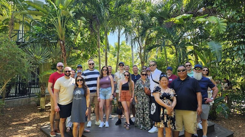 Private corporate group posing together for a photo in the grounds of the Ernest Hemingway Home in Key West