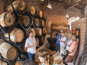 a group of people standing in front of a barrel